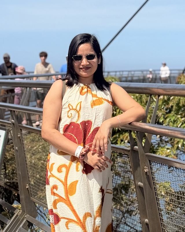 Bhawna Mangla smiling outdoors on a skybridge